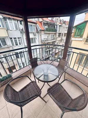 a balcony with a table and chairs on a balcony at Deluxe Apartment Burgas City Centre with Free Parking in Burgas City