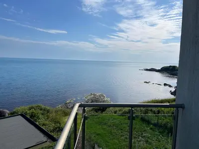 a view of the ocean from a balcony at Вила Арапя in Tsarevo