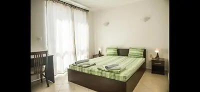 a bedroom with a bed and a large window at Вила Арапя in Tsarevo