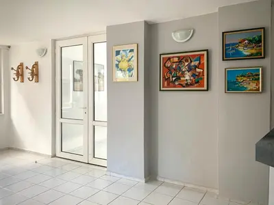a room with a door and pictures on the wall at Тедис хоум in Burgas City
