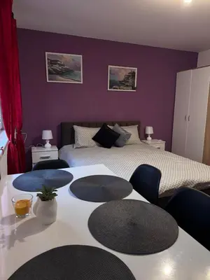 a bedroom with a bed and two tables and chairs at The Central Studio in Burgas City