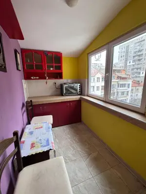 a small kitchen with a table and a microwave at The Central Studio in Burgas City