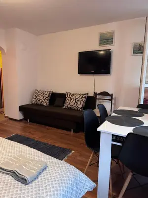 a living room with a couch and a table at The Central Studio in Burgas City