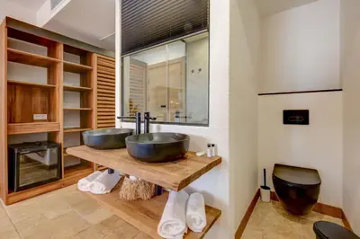 a bathroom with two sinks on a wooden table at La Boheme - Adults Only in Obzor