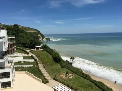 a view of the ocean from the balcony of a building at HPManagement Byala Beach Residence Apartments in Byala
