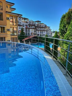 a large swimming pool with buildings in the background at Paradise Dreams Studio in Sveti Vlas