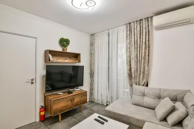 a living room with a couch and a flat screen tv at Super central cozy flat in Varna City
