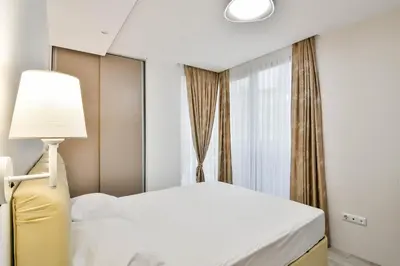 a bedroom with a white bed and a window at Super central cozy flat in Varna City