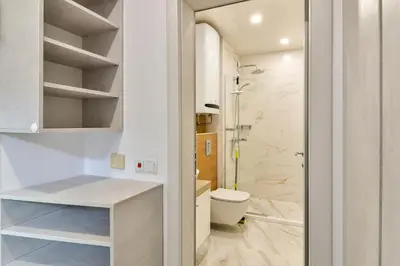 a white bathroom with a toilet and a shower at Super central cozy flat in Varna City