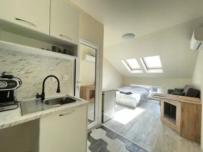 a kitchen with a sink and a bathroom with a bed at Varna Centre Apartment 2 in Varna City