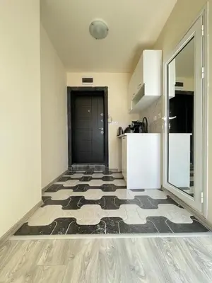 a kitchen with a black door and a tile floor at Varna Centre Apartment 2 in Varna City