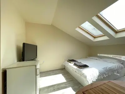 a bedroom with a bed and a flat screen tv at Varna Centre Apartment 2 in Varna City