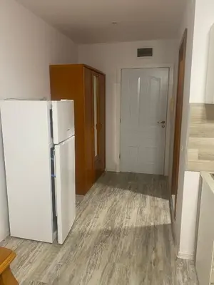a kitchen with a white refrigerator in a room at Краун Форт in Sveti Vlas