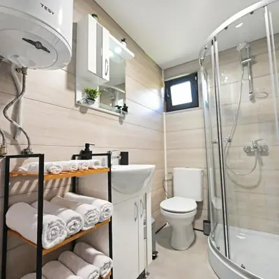 a bathroom with a shower and a sink and a toilet at Black Sea Villas Fichoza in Varna City