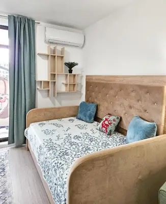 a bedroom with a bed with two pillows on it at FOUR SEASONS Beach Apartment in Pomorie