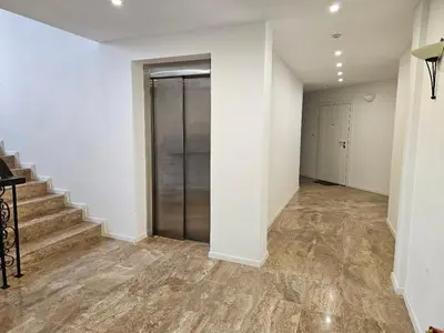 an empty hallway with stairs and a sliding door at FOUR SEASONS Beach Apartment in Pomorie