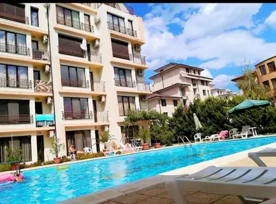 a swimming pool in front of a building at Best Location in Sunny Beach Amber Beach in Sunny Beach
