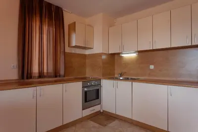 a kitchen with white cabinets and a sink at Вили Vemara club in Byala