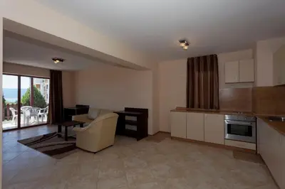 a kitchen and living room with a couch and a table at Вили Vemara club in Byala
