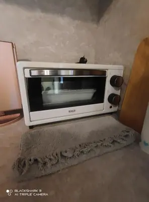 a toaster oven sitting on top of a floor at Tiny House in the center of Varna in Varna City