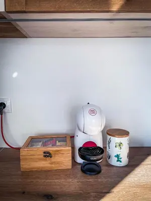 a coffee maker sitting next to a wooden box at Coral Bay Luxury Villa by Lozenets Luxury Villas in Lozenets