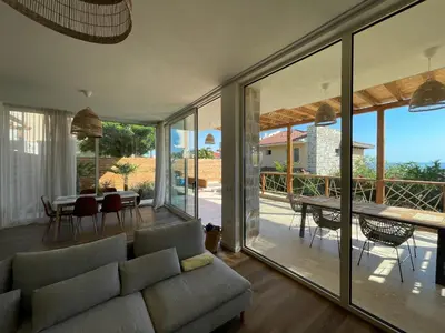 a living room with a couch and a table at Coral Bay Luxury Villa by Lozenets Luxury Villas in Lozenets