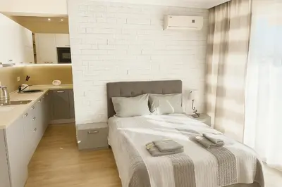 a bedroom with a bed with two towels on it at Marvel Delux Private Studio in Sunny Beach