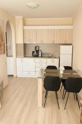 a kitchen with a table and chairs in a room at Poseidon Nessebar Private Apartment in Nesebar