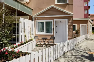 a white picket fence in front of a house at Apartment Hristo in Pomorie