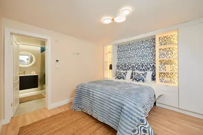 a bedroom with a bed with a blue and white bedspread at Apartment Hristo in Pomorie