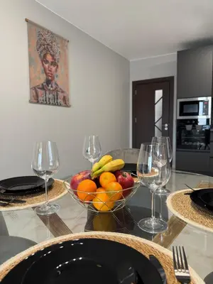 a table with a bowl of fruit and wine glasses at Tea'S Apartment in Varna City
