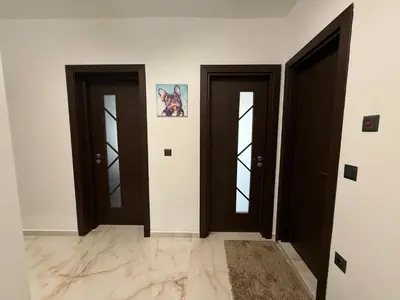 three doors in a room with white walls at Tea'S Apartment in Varna City