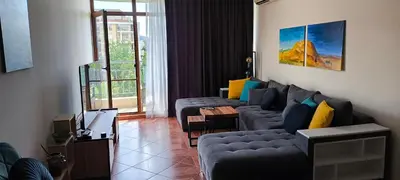 a living room with two couches and a table at Sun Wave Apartment near the Sea in Sveti Vlas