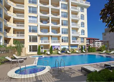 a swimming pool in front of a building at Villa Sardinia Sveti Vlas Studio in Sveti Vlas