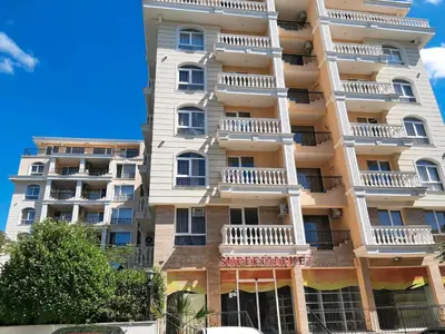 a tall white apartment building with balconies on it at Villa Sardinia Sveti Vlas Studio in Sveti Vlas