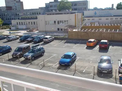 a group of cars parked in a parking lot at Apartamenti Zhelezovi in Pomorie