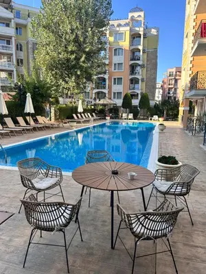 a table and chairs next to a swimming pool at Sea Home 1 in Sunny Beach