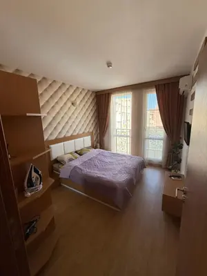 a bedroom with a bed and two windows at Sea Home 1 in Sunny Beach