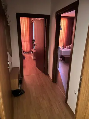 a hallway with a door and a room with a table at Sea Home 1 in Sunny Beach
