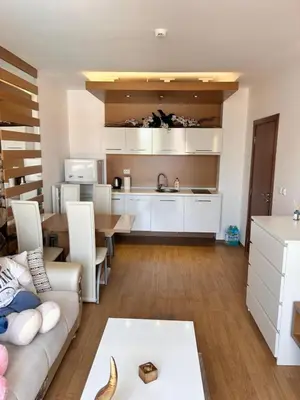 a kitchen and living room with a couch and a table at Sea Home 1 in Sunny Beach