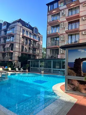 a swimming pool in front of two tall buildings at Sea Home in Sunny Beach