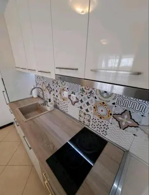 a kitchen with white cabinets and a sink and a stove at Top Oasis Park Lozenets apartment in Lozenets