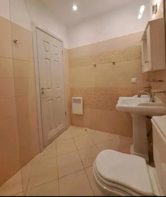 a bathroom with a toilet and a sink at Top Oasis Park Lozenets apartment in Lozenets