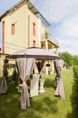 a large umbrella on the grass in front of a house at Villa SeaBreeze in Varna City
