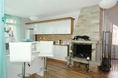 a kitchen with a stone fireplace in a room at Villa SeaBreeze in Varna City