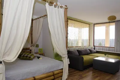 a bedroom with a canopy bed and a couch at Villa SeaBreeze in Varna City