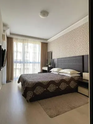a bedroom with a large bed and a large window at Palma Beach in Harmony Suites 2,3 in Sunny Beach