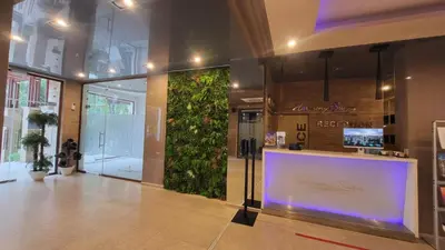 a lobby with a large green wall in a building at Palma Beach in Harmony Suites 2,3 in Sunny Beach