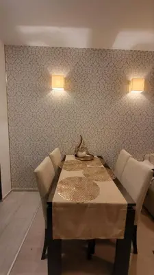 a dining room with a table and chairs and lights at Palma Beach in Harmony Suites 2,3 in Sunny Beach