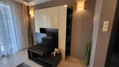 a living room with a television and a mirror at Palma Beach in Harmony Suites 2,3 in Sunny Beach